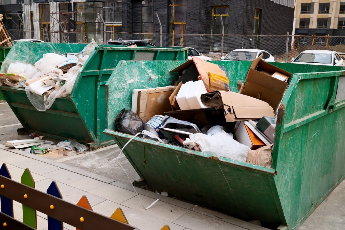 Construction dumpster filled with building waste at an urban site